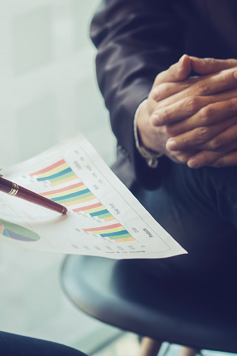 Businessmen looking at reports to sell a business