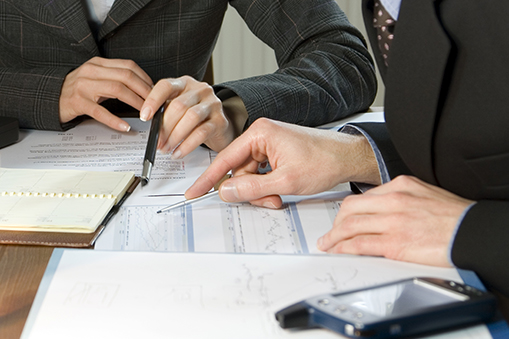 Two business people looking at business valuation documents